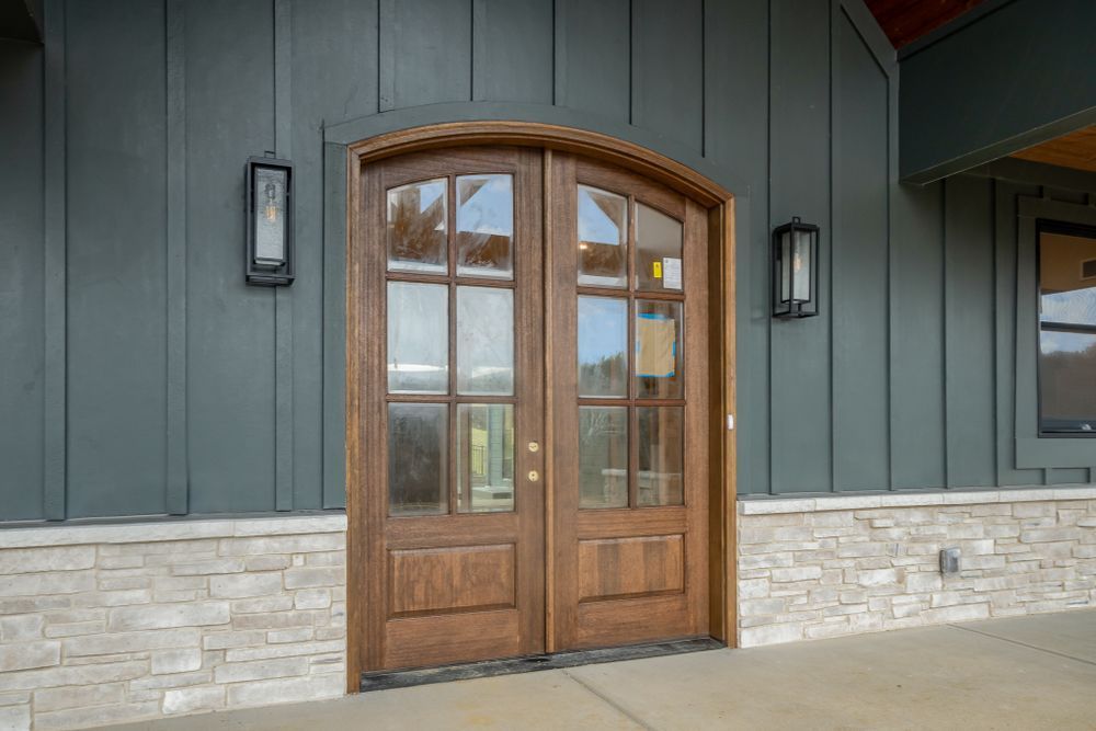 A pair of wooden doors on the side of a building.