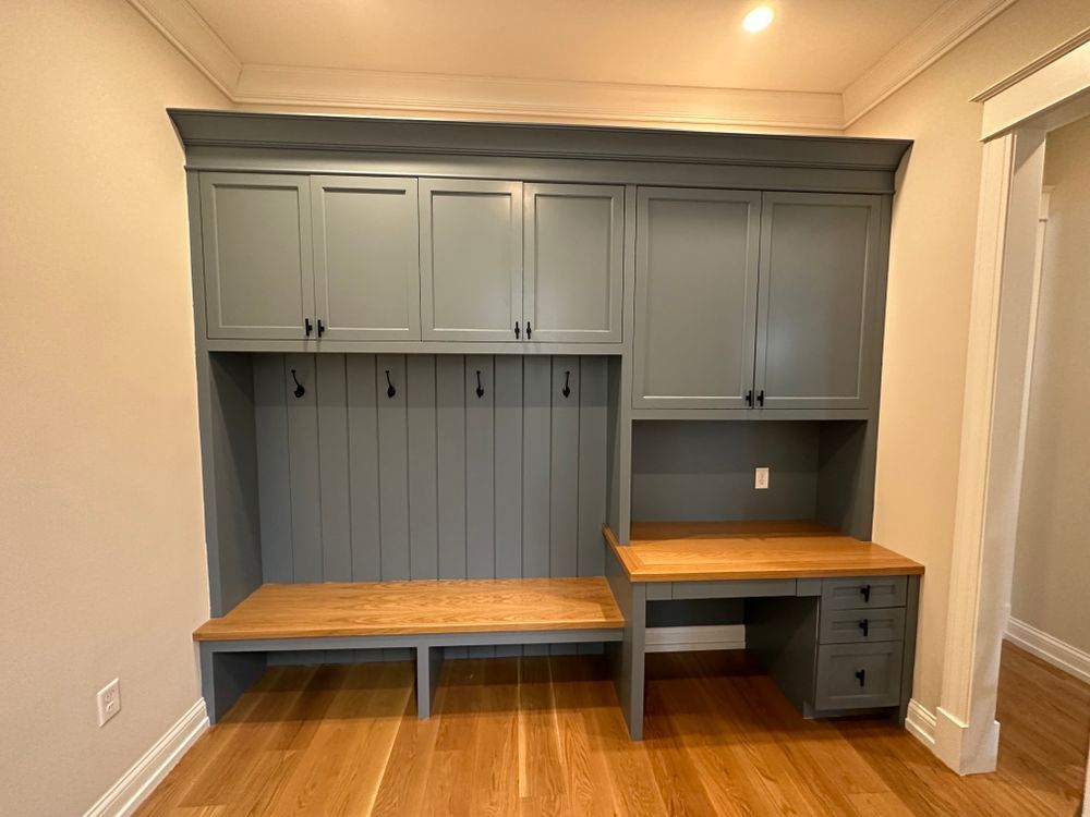 A room with a desk and a bench in it