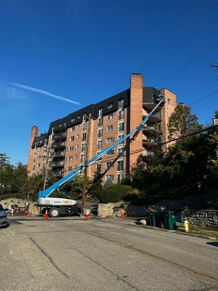 A large brick building with a crane in front of it