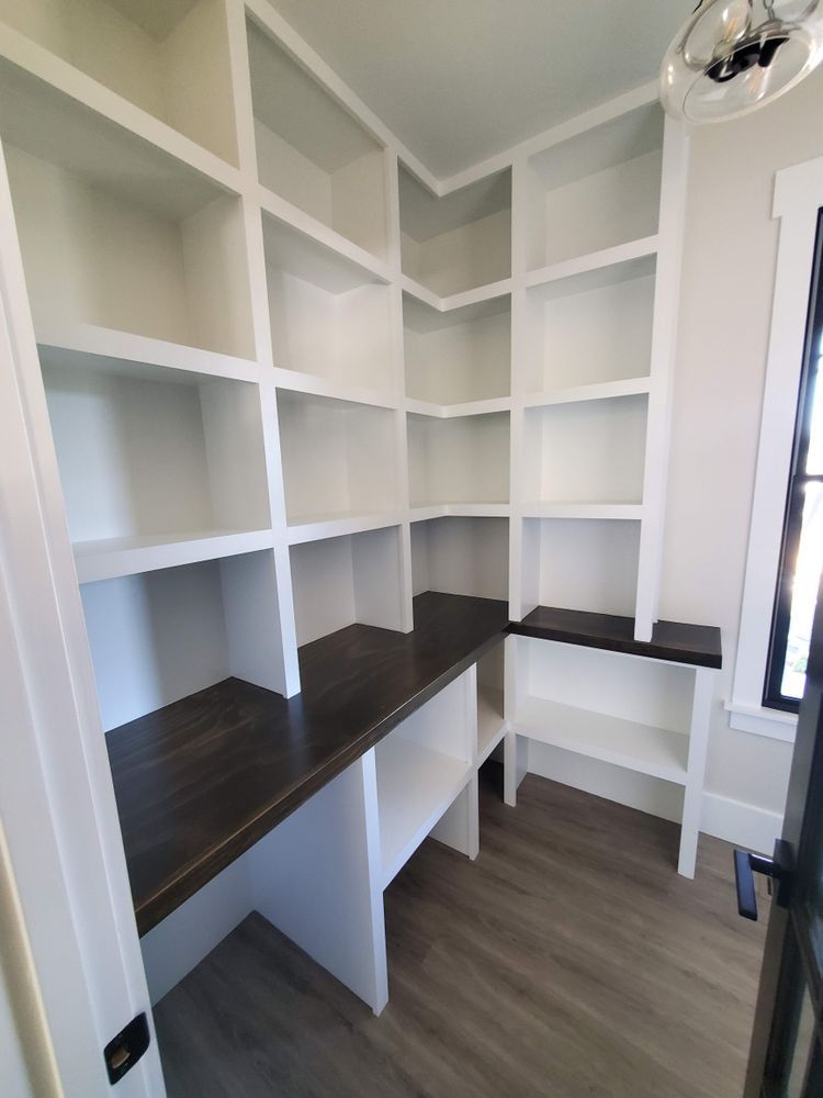 A room with a lot of shelves and a desk