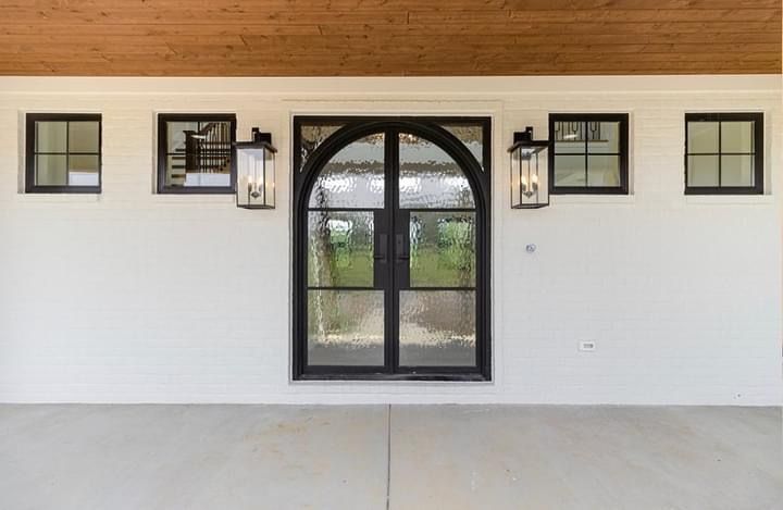 A white house with black windows and a black door.