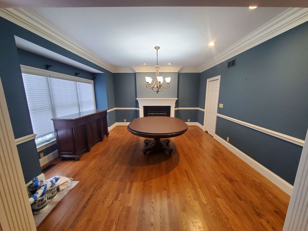 A dining room with a round table and a fireplace.