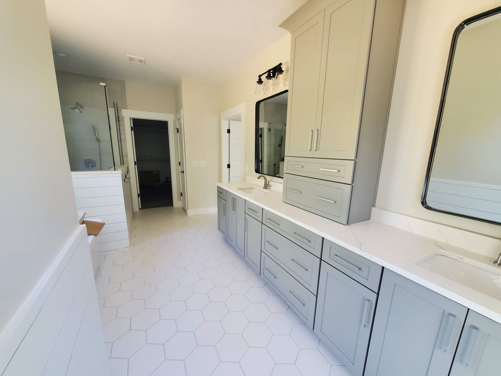 A bathroom with a lot of cabinets and a mirror