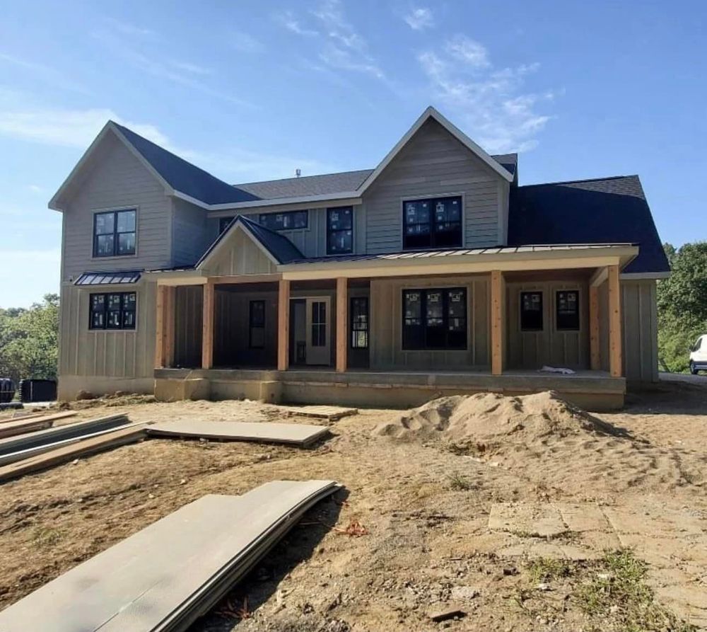 A large house with a large porch is being built