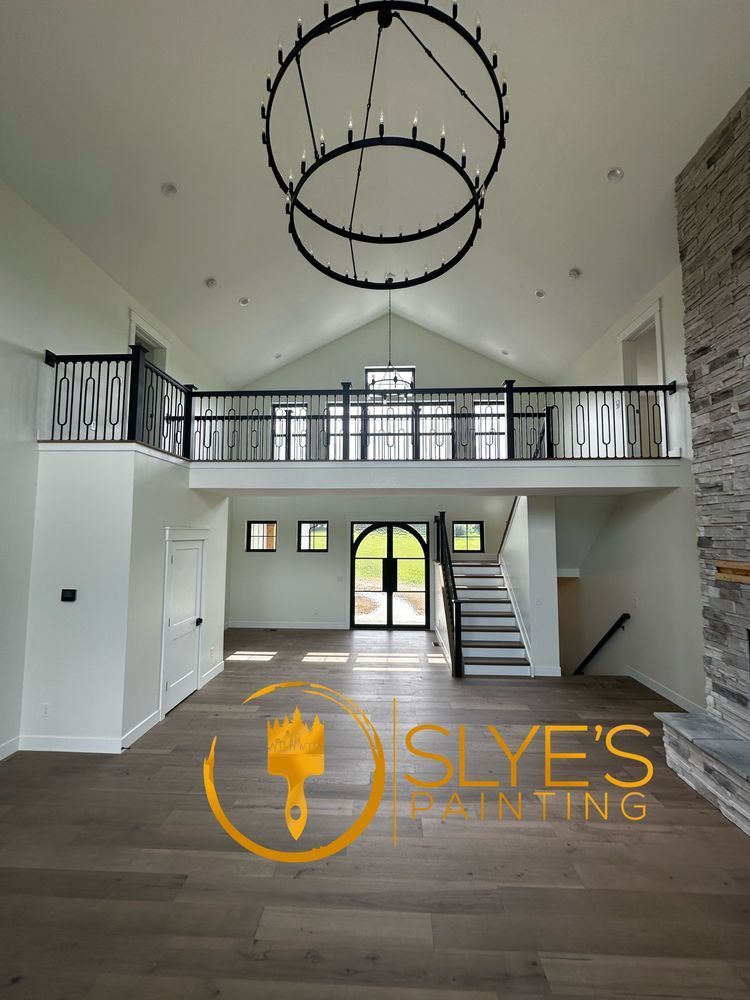 A large empty room with a logo for slye 's painting