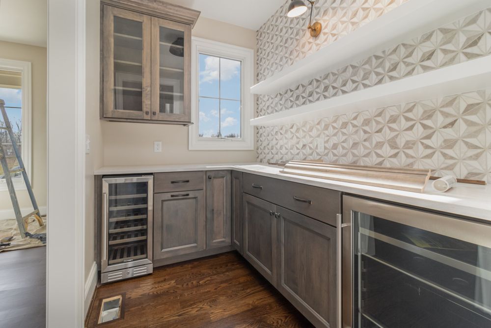 A kitchen with stainless steel appliances and a wine cooler.