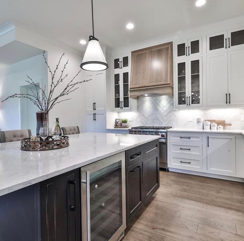 A kitchen with stainless steel appliances and white cabinets