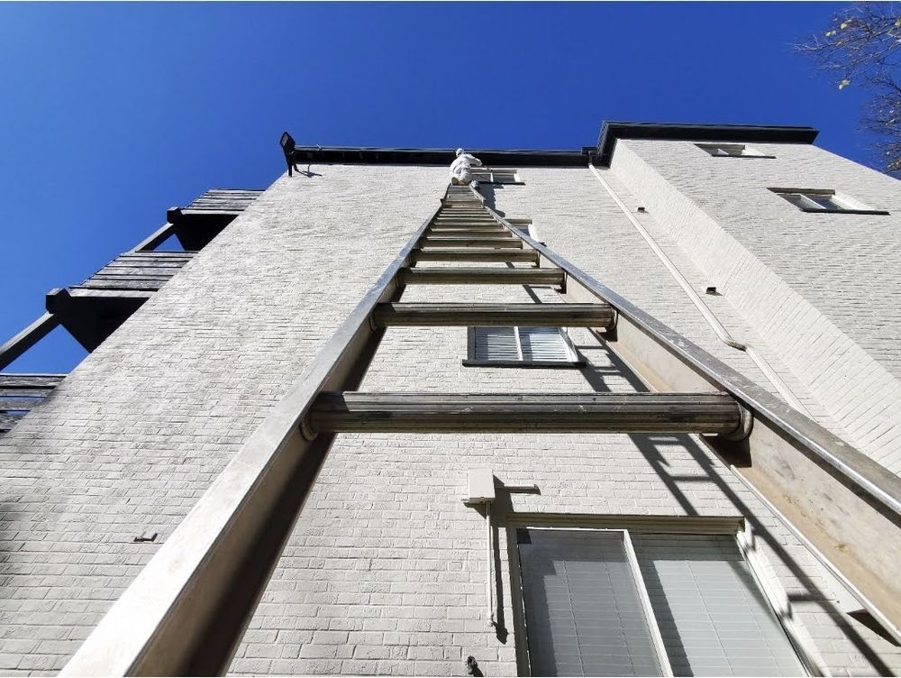 A ladder is attached to the side of a building