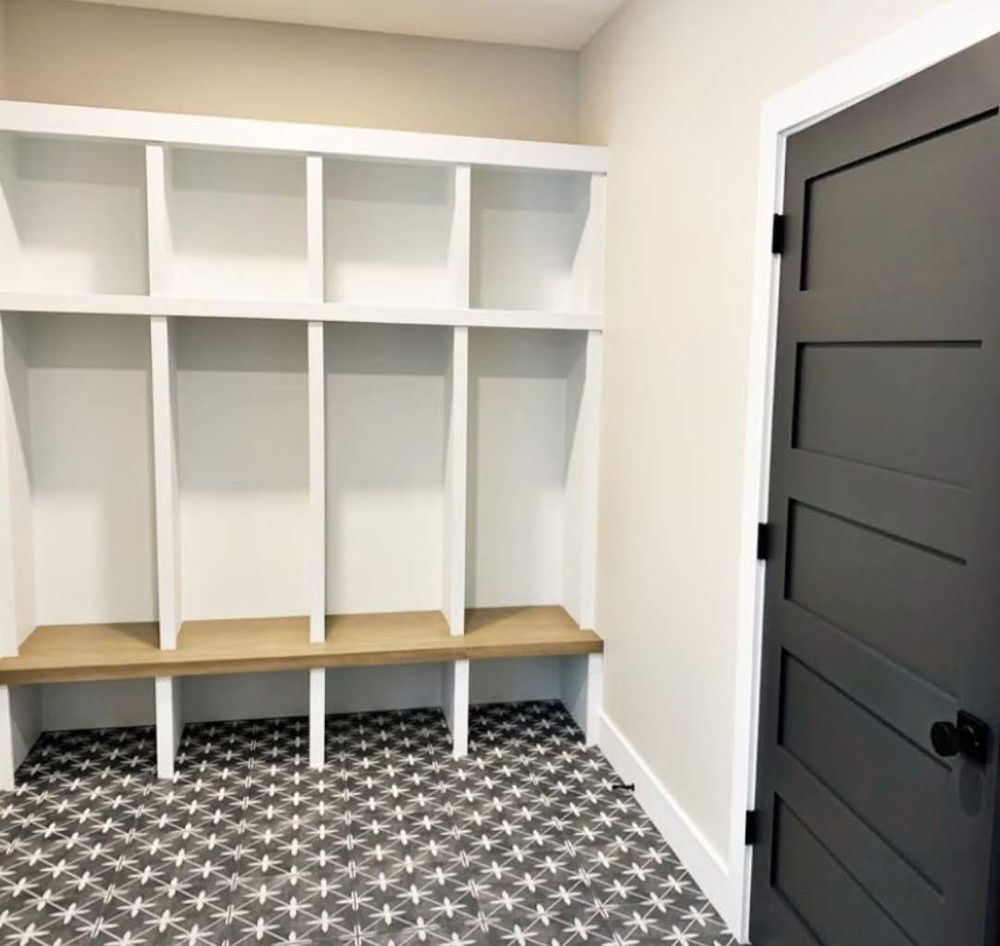 A room with shelves and a black door
