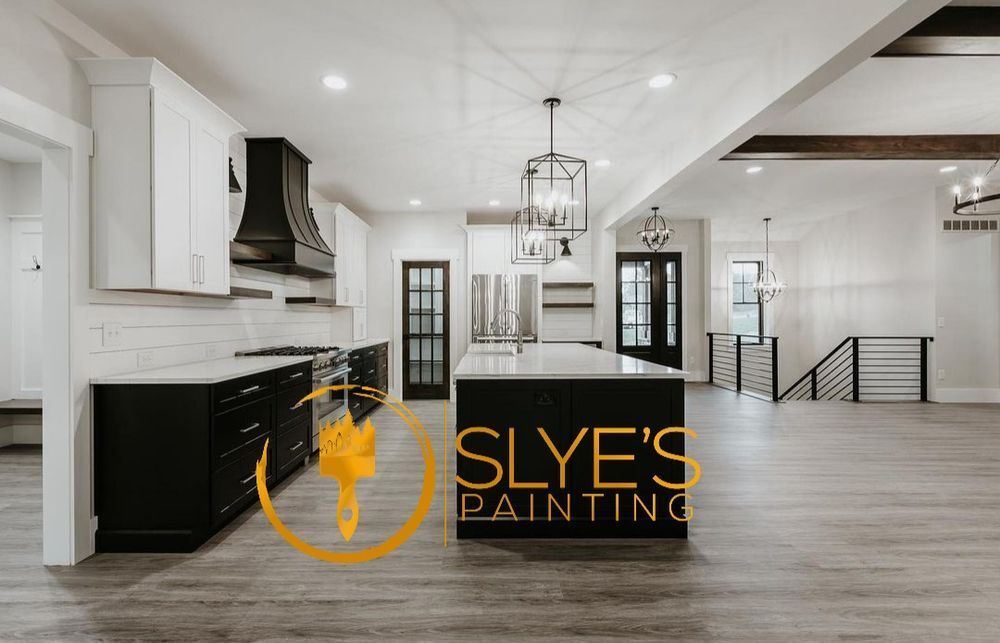 A kitchen with a large island and a logo for slye 's painting