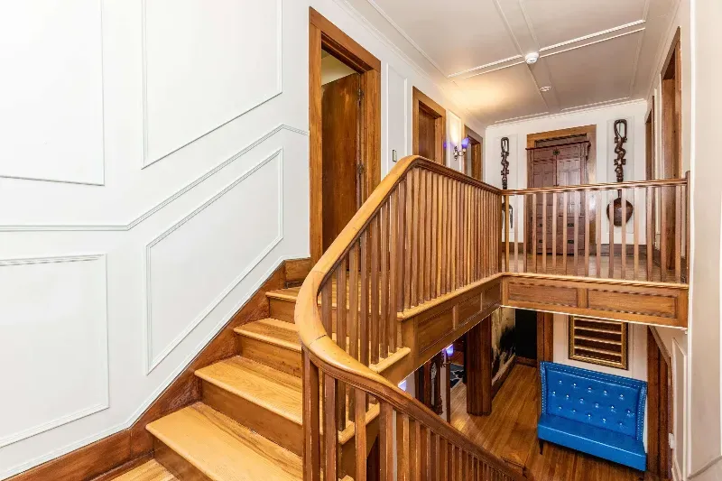 A wooden staircase leading up to a second floor in a house.
