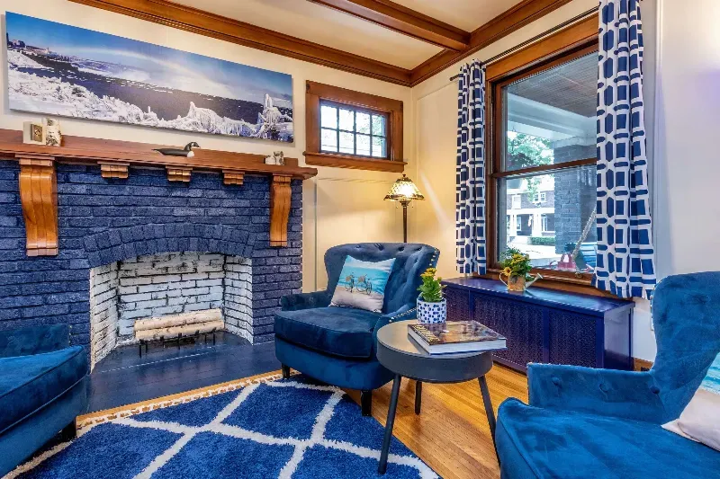 A living room with blue furniture and a blue fireplace.