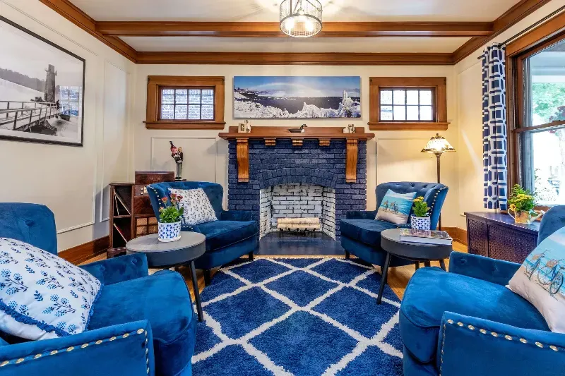 A living room with blue furniture and a blue fireplace.