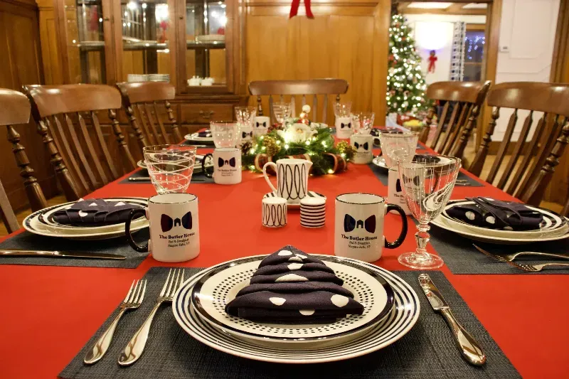 A dining room table set for a christmas dinner