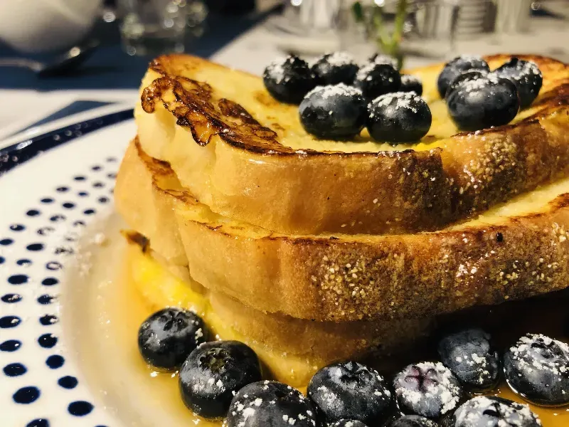 French toast with blueberries and syrup on a plate