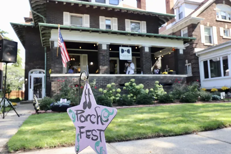 A house with a porch fest sign in front of it