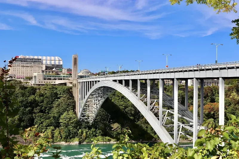 A bridge over a river with a blue sky in the background.
