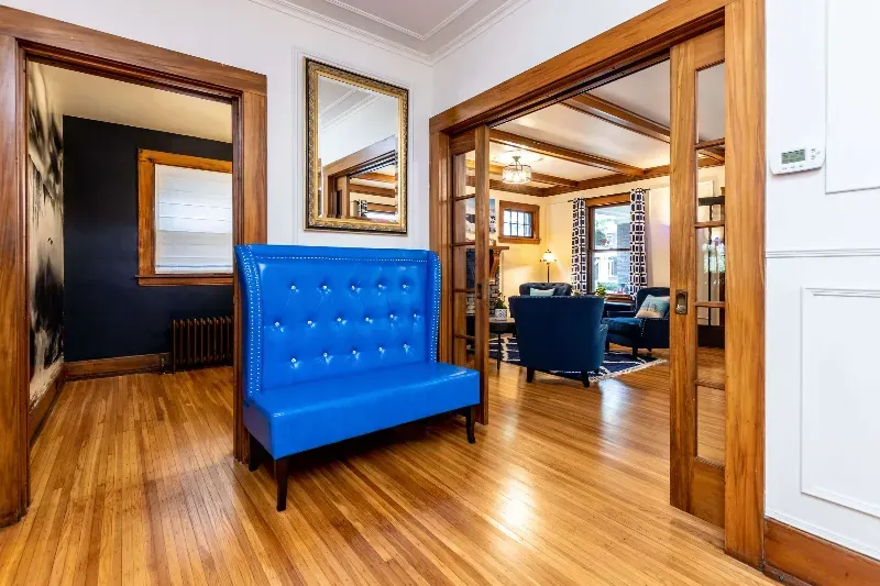 There is a blue couch in the middle of the room.