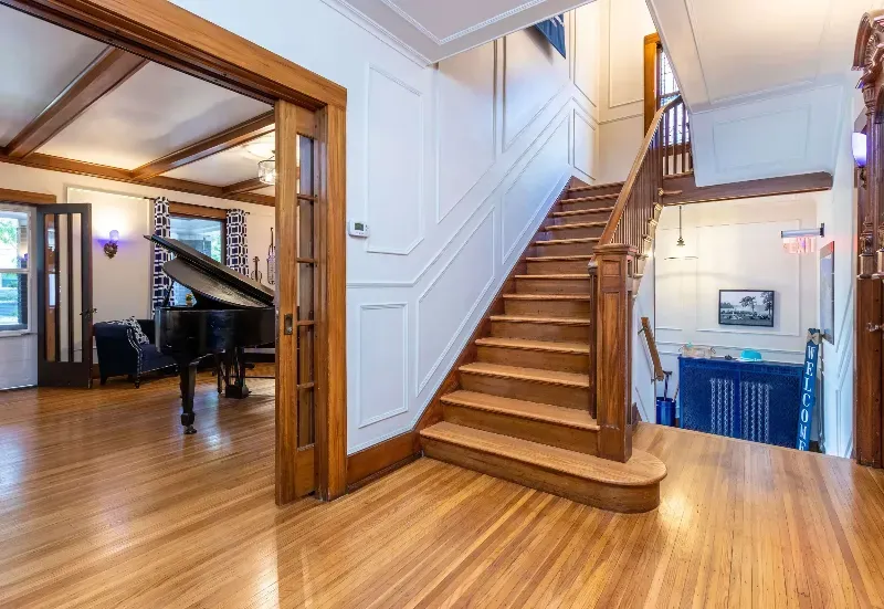 A large wooden staircase leading up to the second floor of a house.