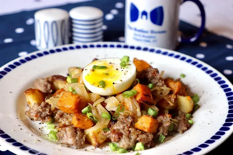 A plate of food with a hard boiled egg on top