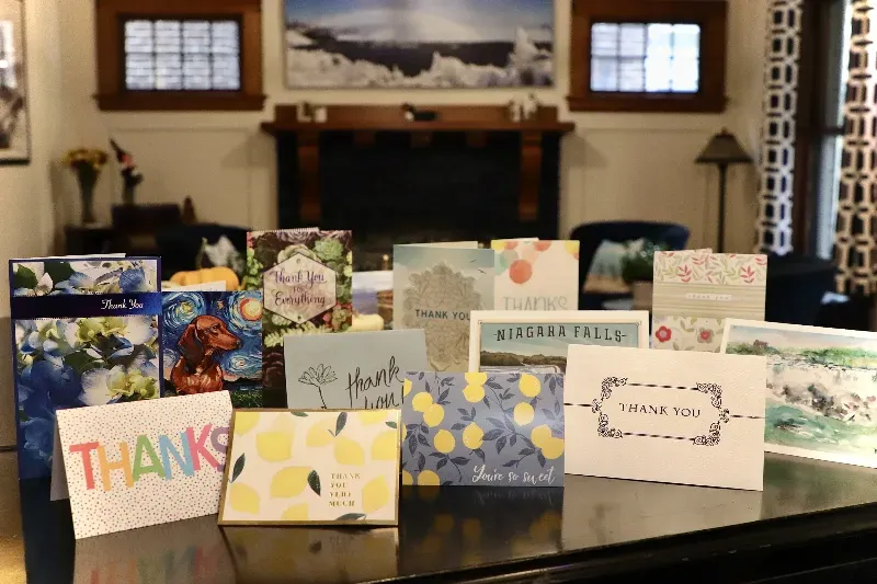 A bunch of thank you cards are sitting on a table.