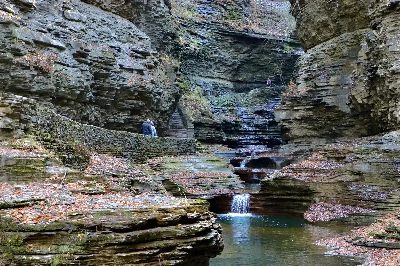 There is a waterfall in the middle of a canyon.