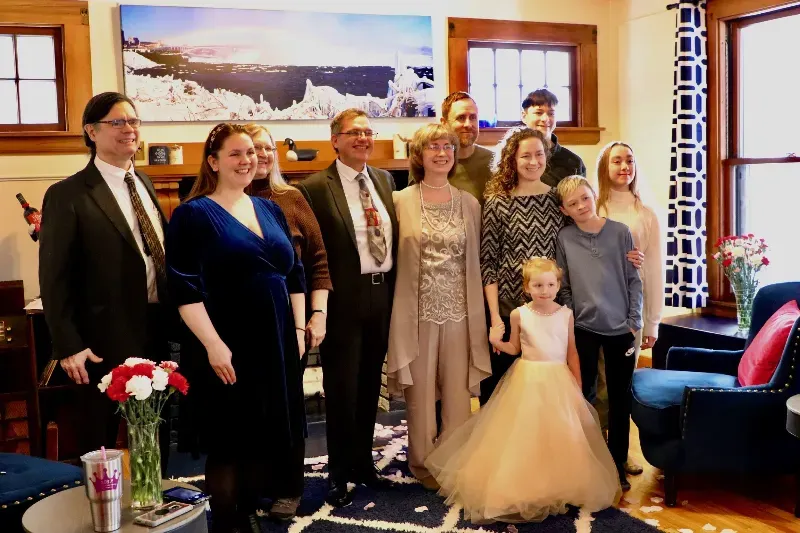 A large family posing for a picture in a living room