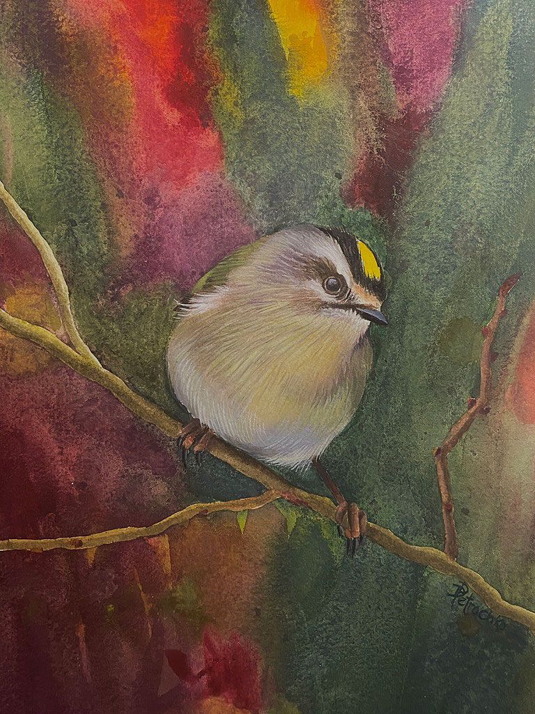 A small bird with a yellow crest perched on a thin branch against a soft, colorful, impressionistic background.