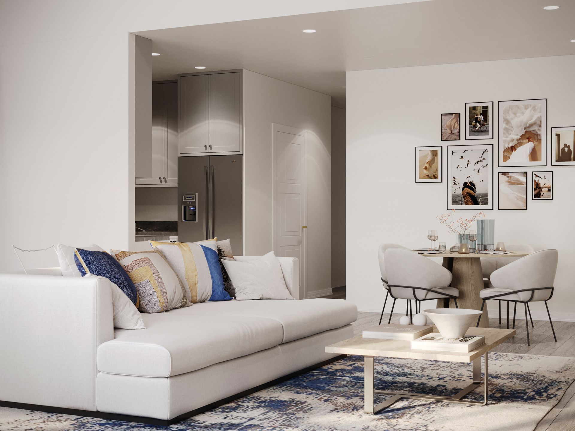 A living room with a white couch , coffee table and chairs.