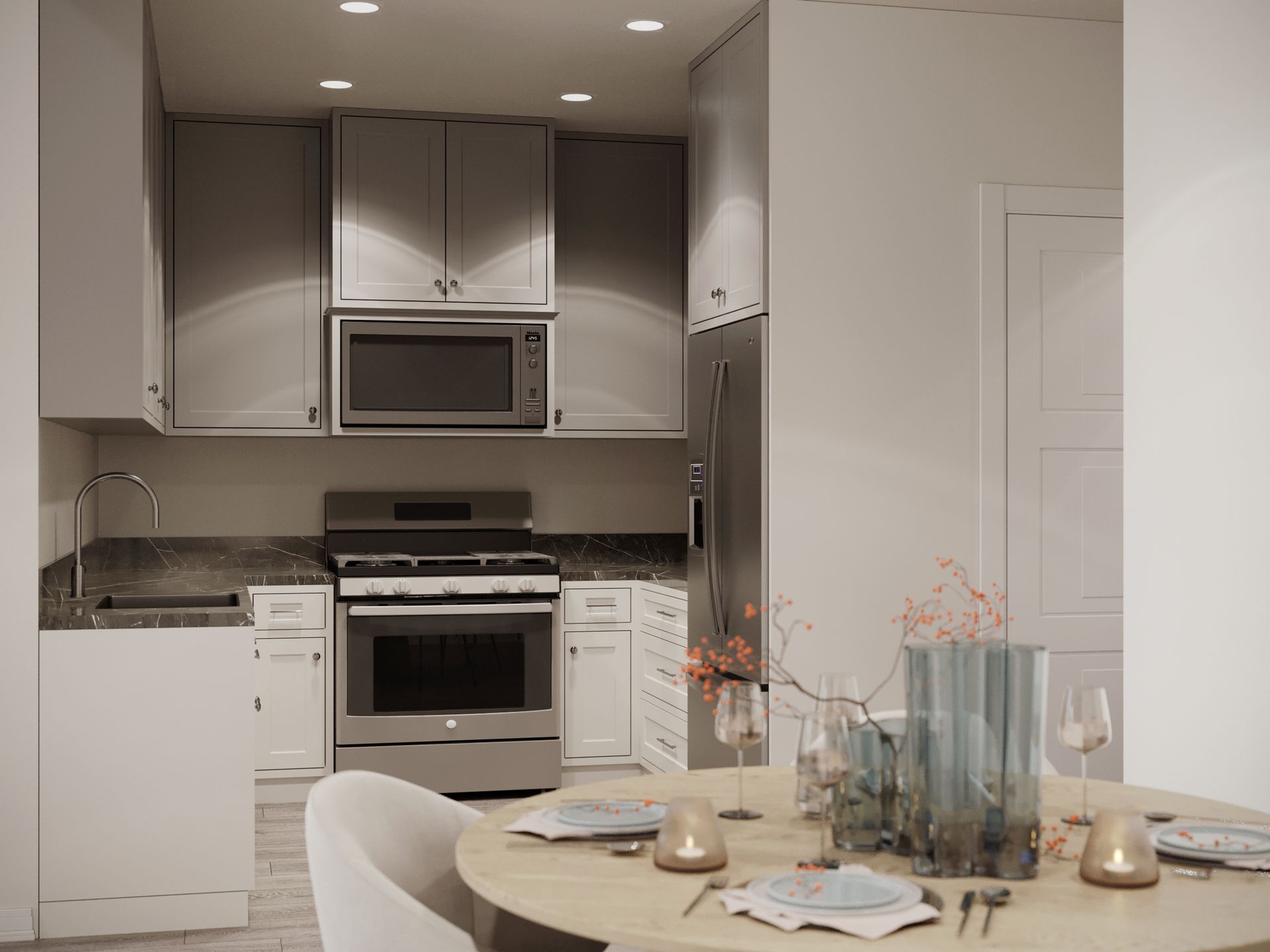 A kitchen with stainless steel appliances and a dining table