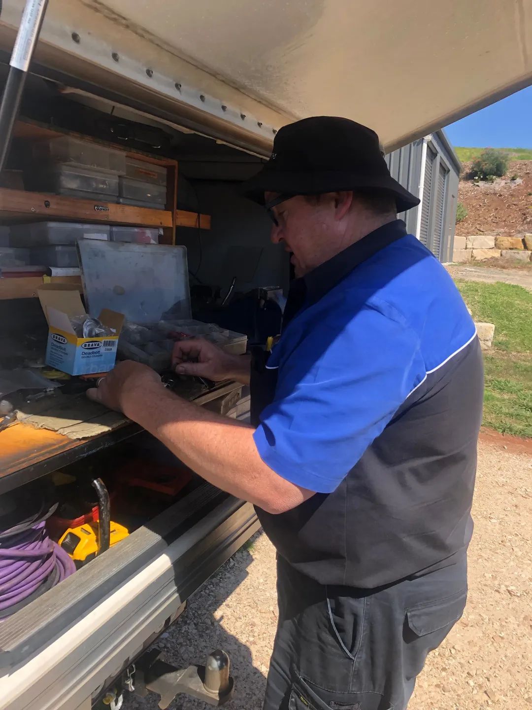 Man in Blue and Black Work Shirt and Black Hat Sort — Suresafe Locksmiths in Glenvale, QLD