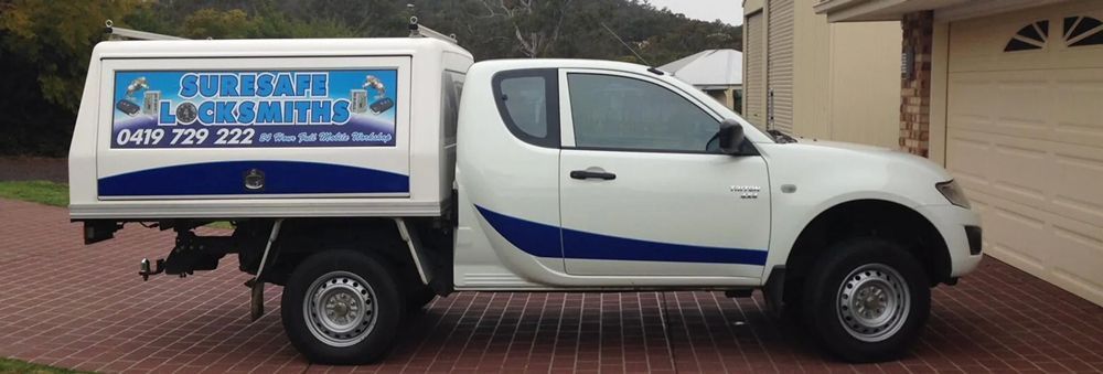 A White Truck is Parked in Front of a House — Suresafe Locksmiths in Glenvale, QLD