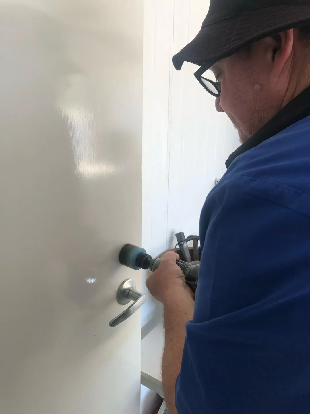 A Man in a Shirt is Working — Suresafe Locksmiths in Westbrook, QLD