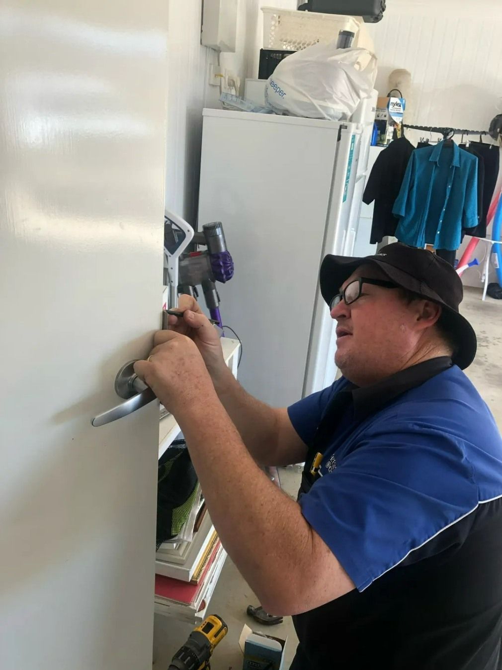 A Man is Working on a Door — Suresafe Locksmiths in Glenvale, QLD