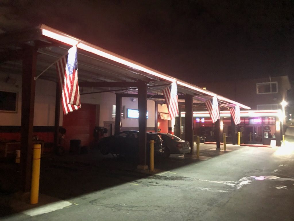 car under covering shop front | Factory Direct Tire Sales