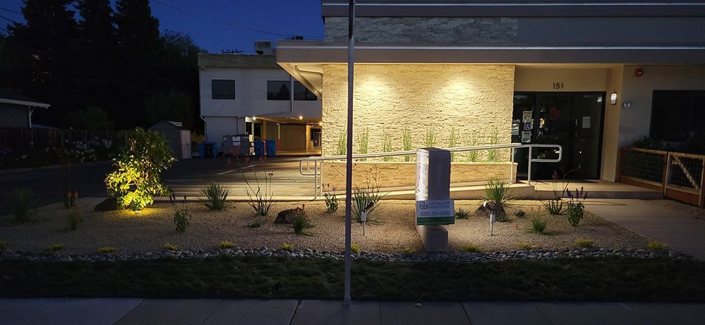 The front of a house is lit up at night.
