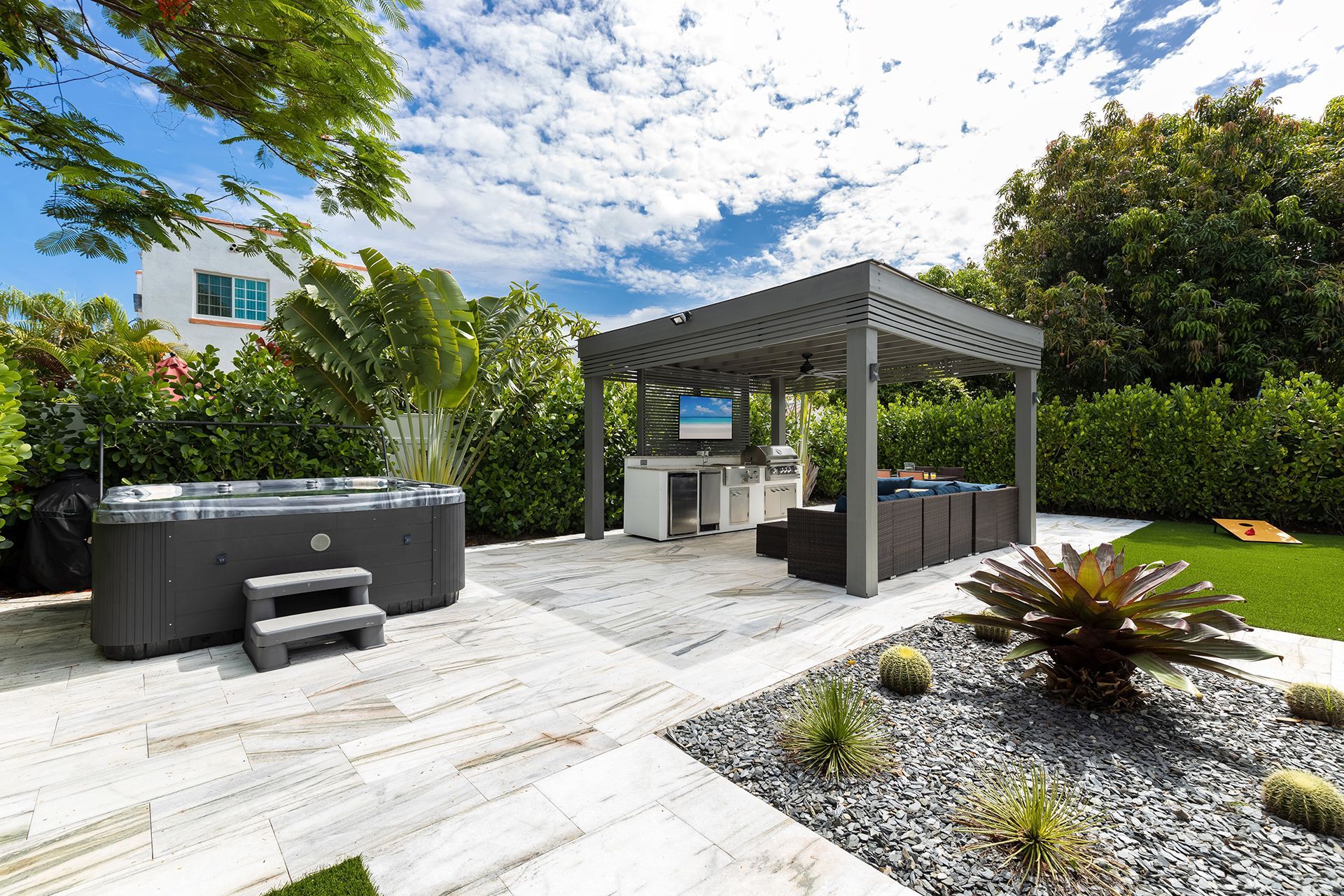 A backyard with a hot tub and a gazebo