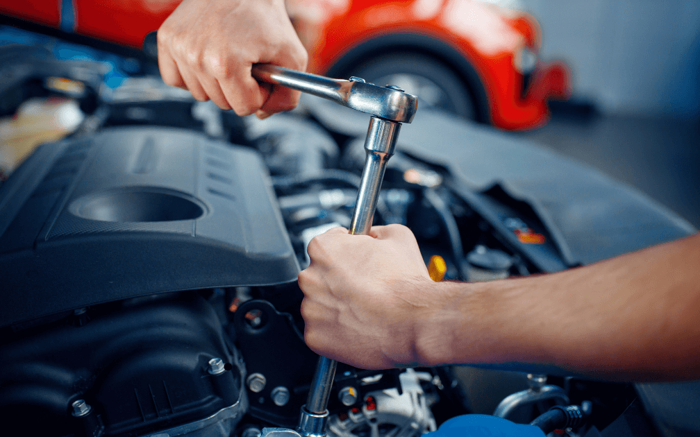 a mechanic doing a pre-purchase inspection on a white car with white interior seats