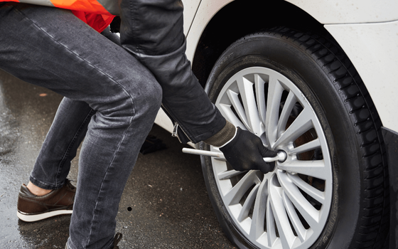 a mechanic doing a pre-purchase inspection on a white car with white interior seats