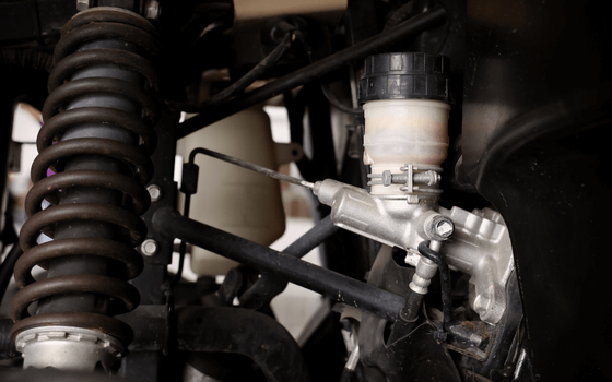 a mechanic doing a pre-purchase inspection on a white car with white interior seats