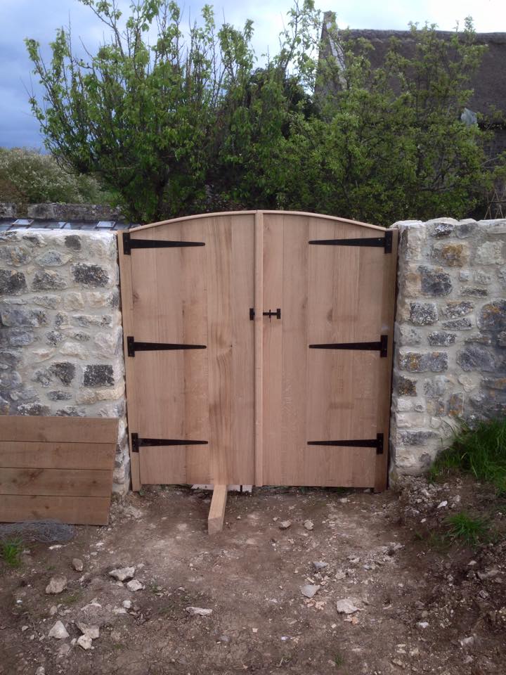 wooden entrance gate newly fitted by carpenters