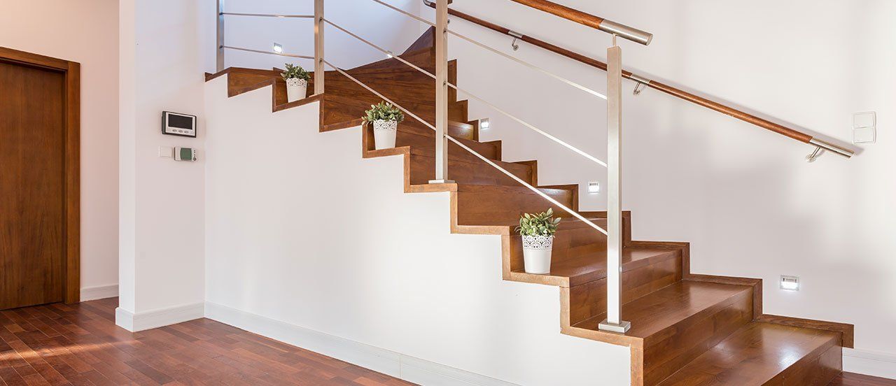 newly installed staircase for home with plant pots kept on stairs