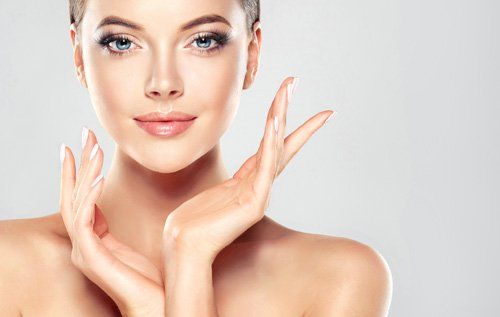 Cosmetic Surgery - Beautiful woman touching her face in Joliet, IL
