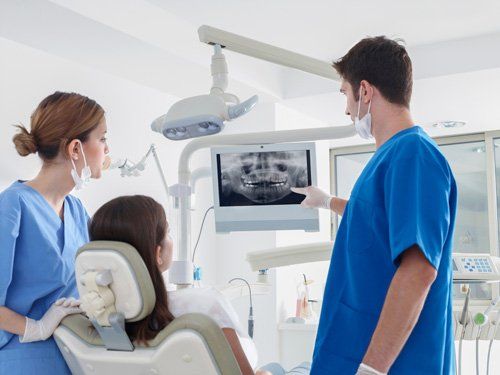 Oral Surgery - Dentist discussing the x-ray result of teeth in Joliet, IL