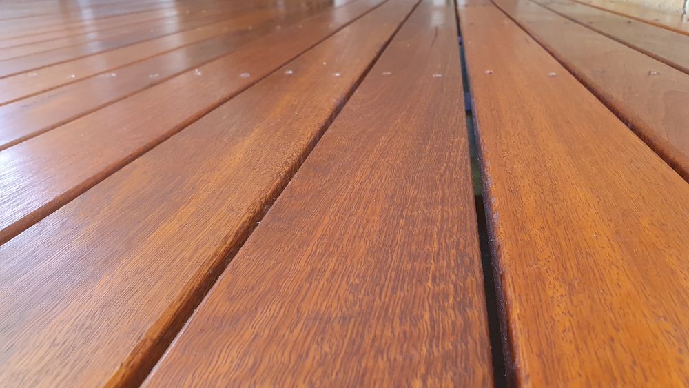 Close-up of a wooden deck with polished, reddish-brown planks.