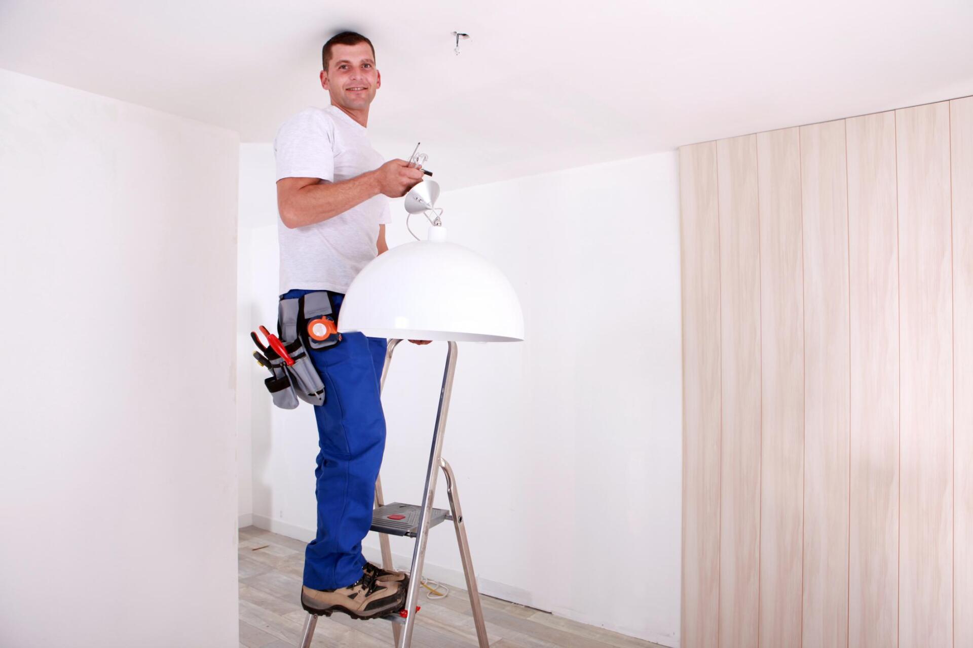 man installing a chandelier