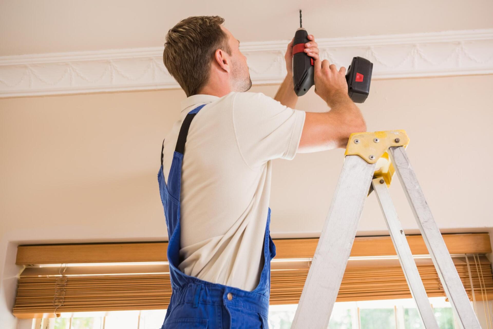 handyman repairing ceiling