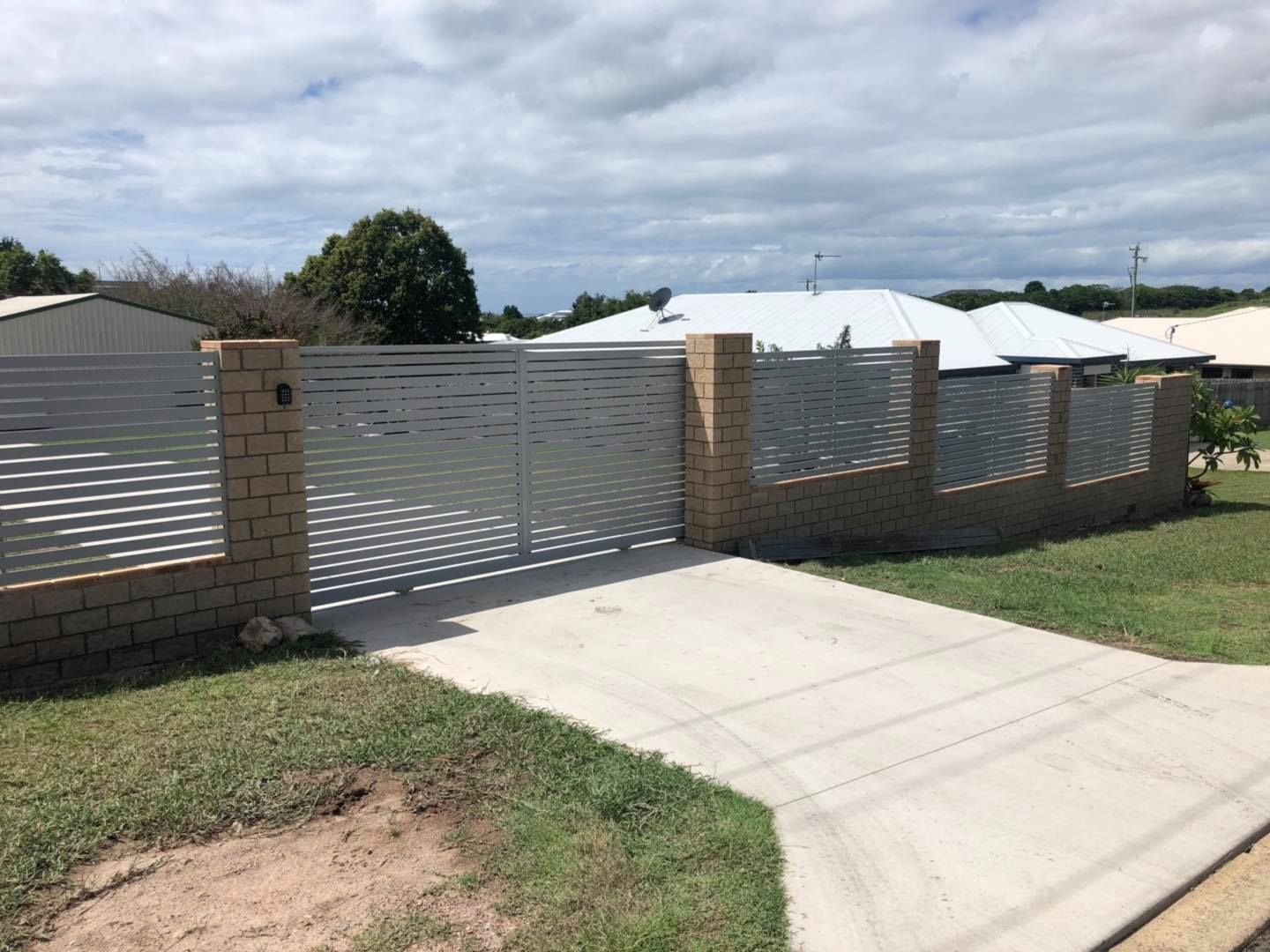 Driveway Leading to a House With a Fence and a Gate — Lange's Fencing and Landscaping Centre in Gympie, QLD