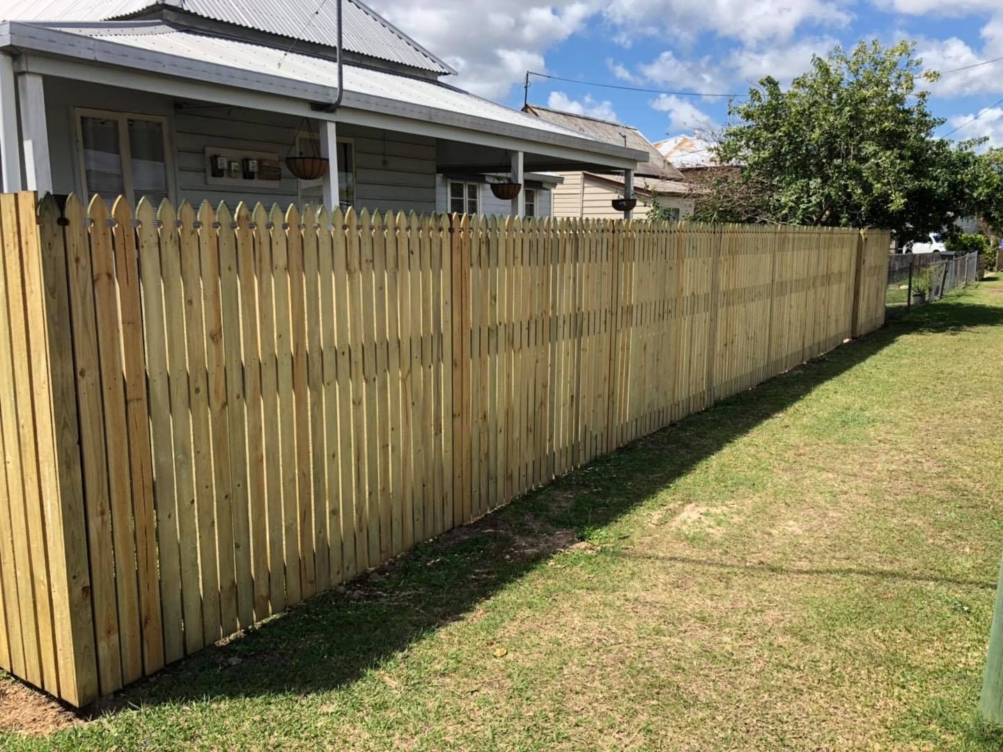 Wooden picket fence and a House — Lange's Fencing and Landscaping Centre in Island Plantation, QLD