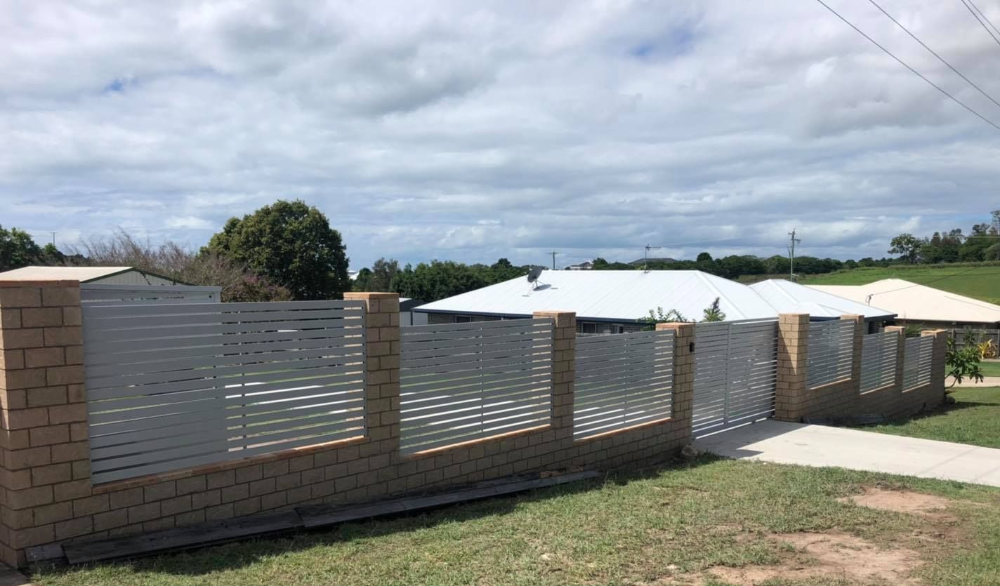 White Fence is Surrounded by Grass and Trees — Lange's Fencing and Landscaping Centre in Island Plantation, QLD